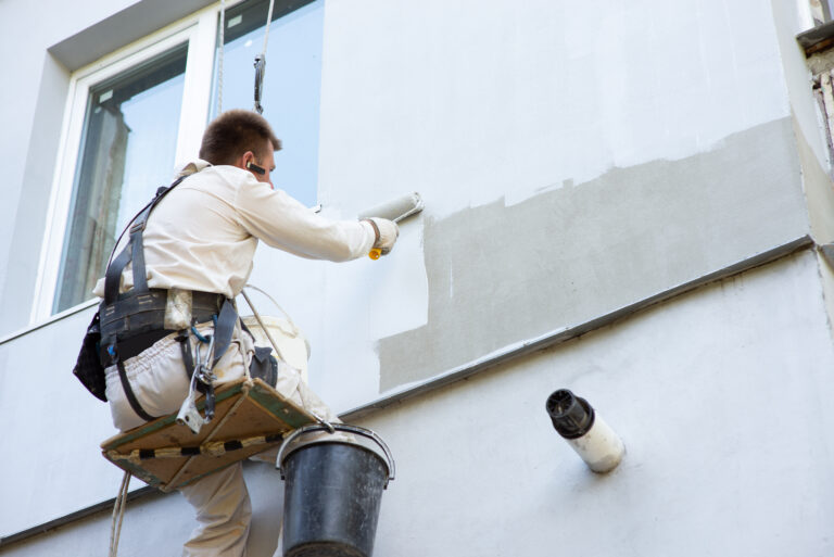 Facade worker working on facade renovation